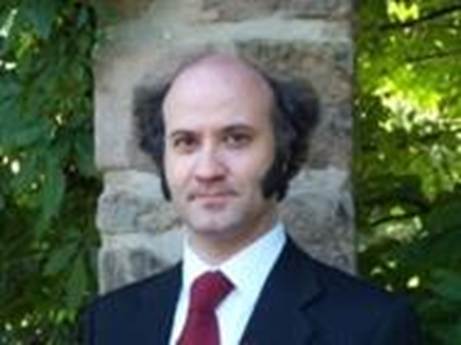 A person in a suit and tie

AI-generated content may be incorrect.